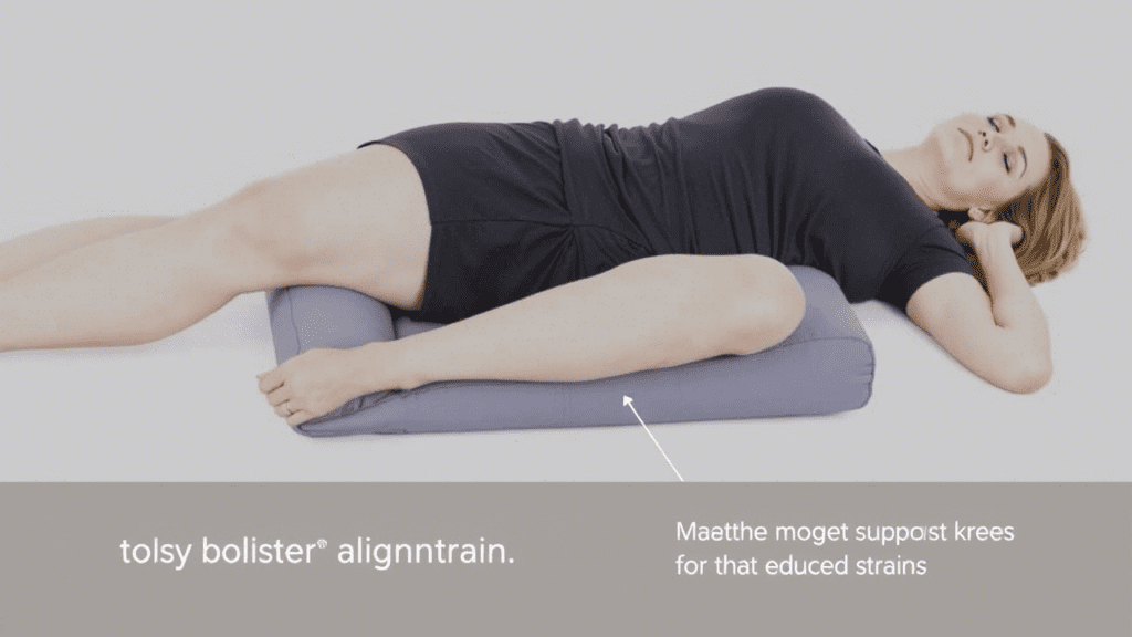 A woman with a black t-shirt on a yoga mat with