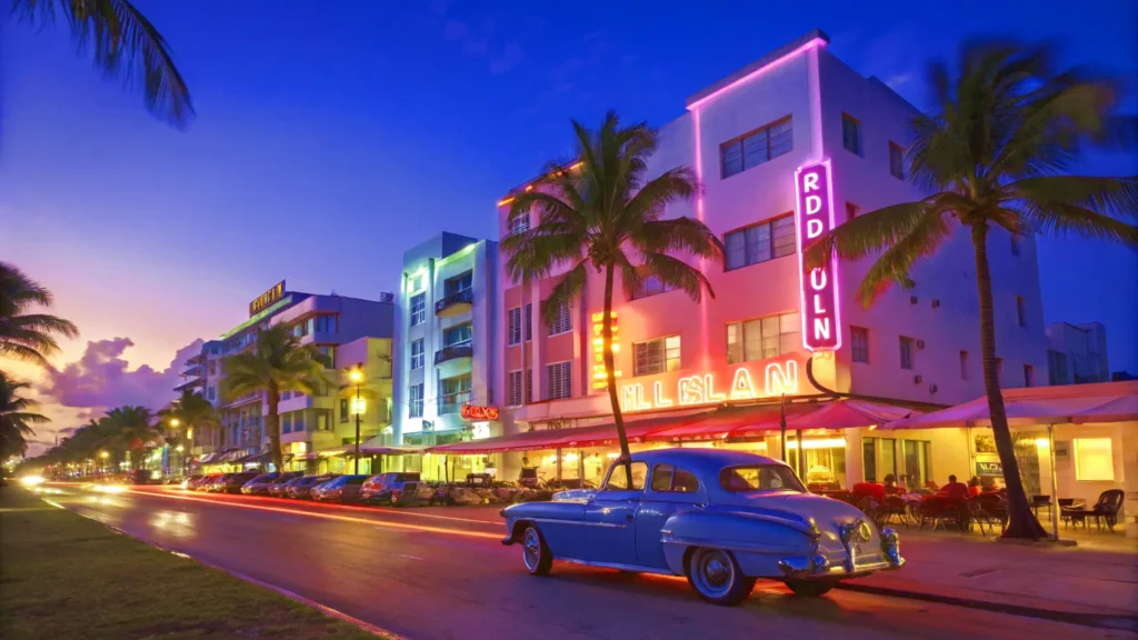 Glowing neon signs on the Art Deco hotels of Ocean Drive in Miami at dusk, a vibrant stop on a Florida road trip.