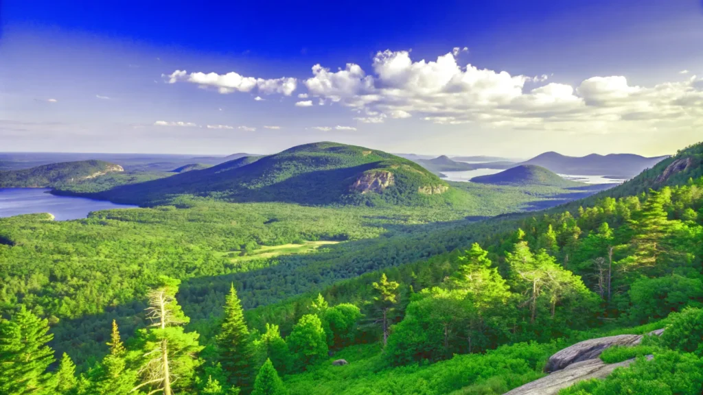 Scenic view of mountains with a serene lake in the background, capturing the essence of a New England road trip..