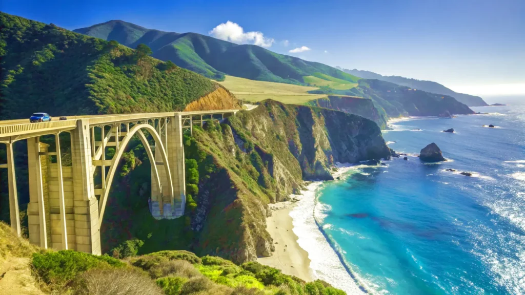 The iconic Bixby Creek Bridge in Big Sur on a sunny day, a must-see landmark on a California west coast road trip.