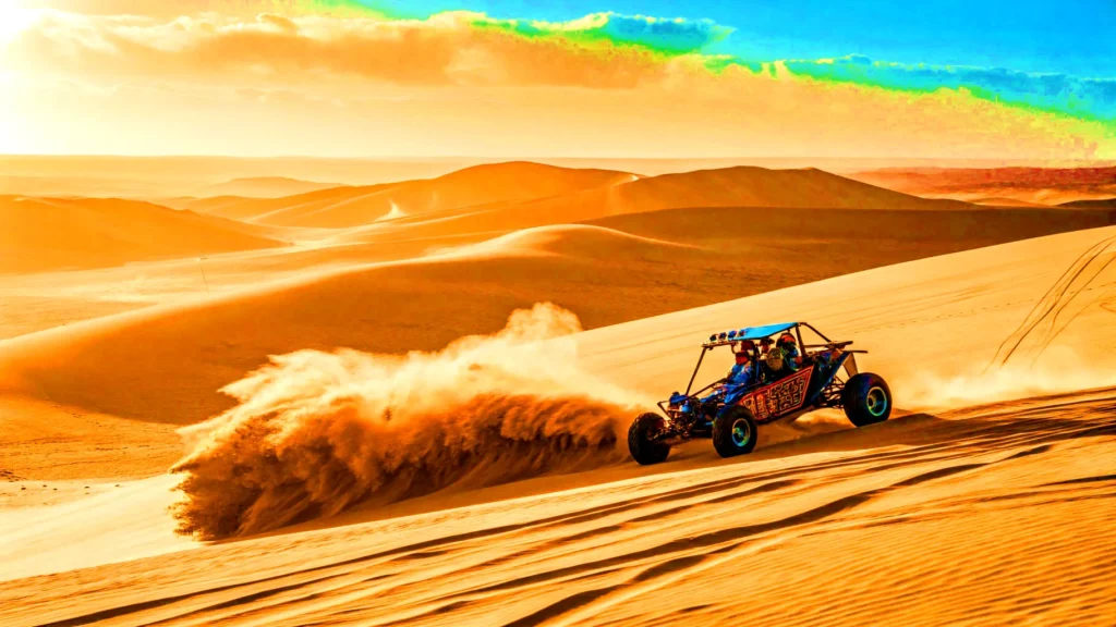 A man driving a vehicle over a sandy dune during an Oregon coast road trip.